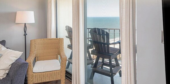 A balcony with wicker chairs and a view of the ocean. - Beautiful 2 Bedroom at the 9400 Building with panoramic views of Ocean City! (Ocean City)