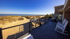 A wooden deck with a view of the beach and ocean. - The Good Stuff - Oceanfront charmer with direct beach access (Virginia Beach)
