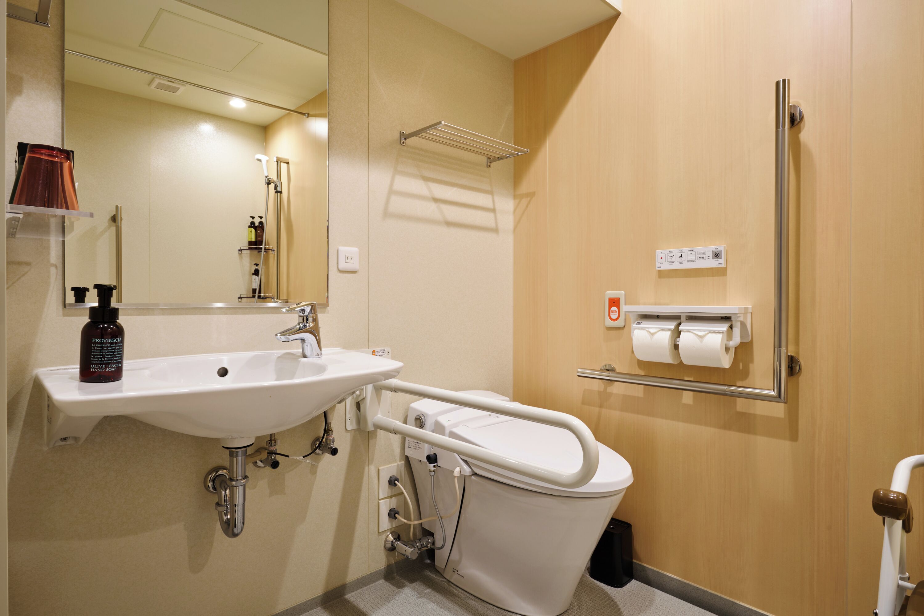 A bathroom with a sink, toilet, and shower.