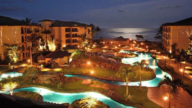 A resort with multiple swimming pools, a water slide, and beachfront views. - Waipouli Beach Oceanfront Resort (Kapaa)