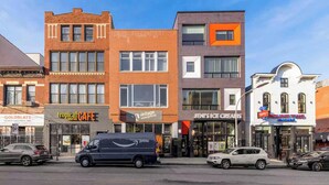 A street view with various commercial buildings, including a vintage underground store, a cafe, and an ice cream shop.