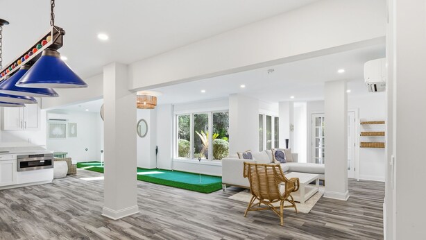 A spacious living area with a pool, white furniture, and a modern design. - Beautiful Palmetto Dunes home with bikes, pool, hot tub. (Hilton Head Island)