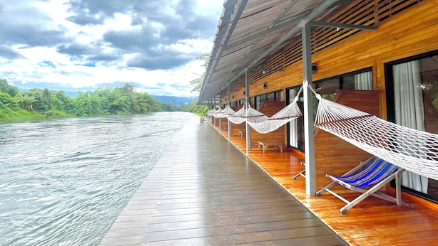 A wooden deck with hammocks and a river view. - Mataburi River Kwai Resort (Sai Yok)