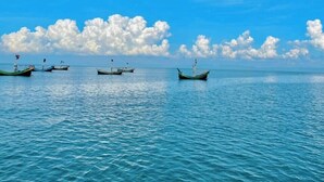 A calm sea with several boats floating on the water under a clear blue sky. - Sea Probal Beach Resort Saint Martin (Saint Martin's Island)
