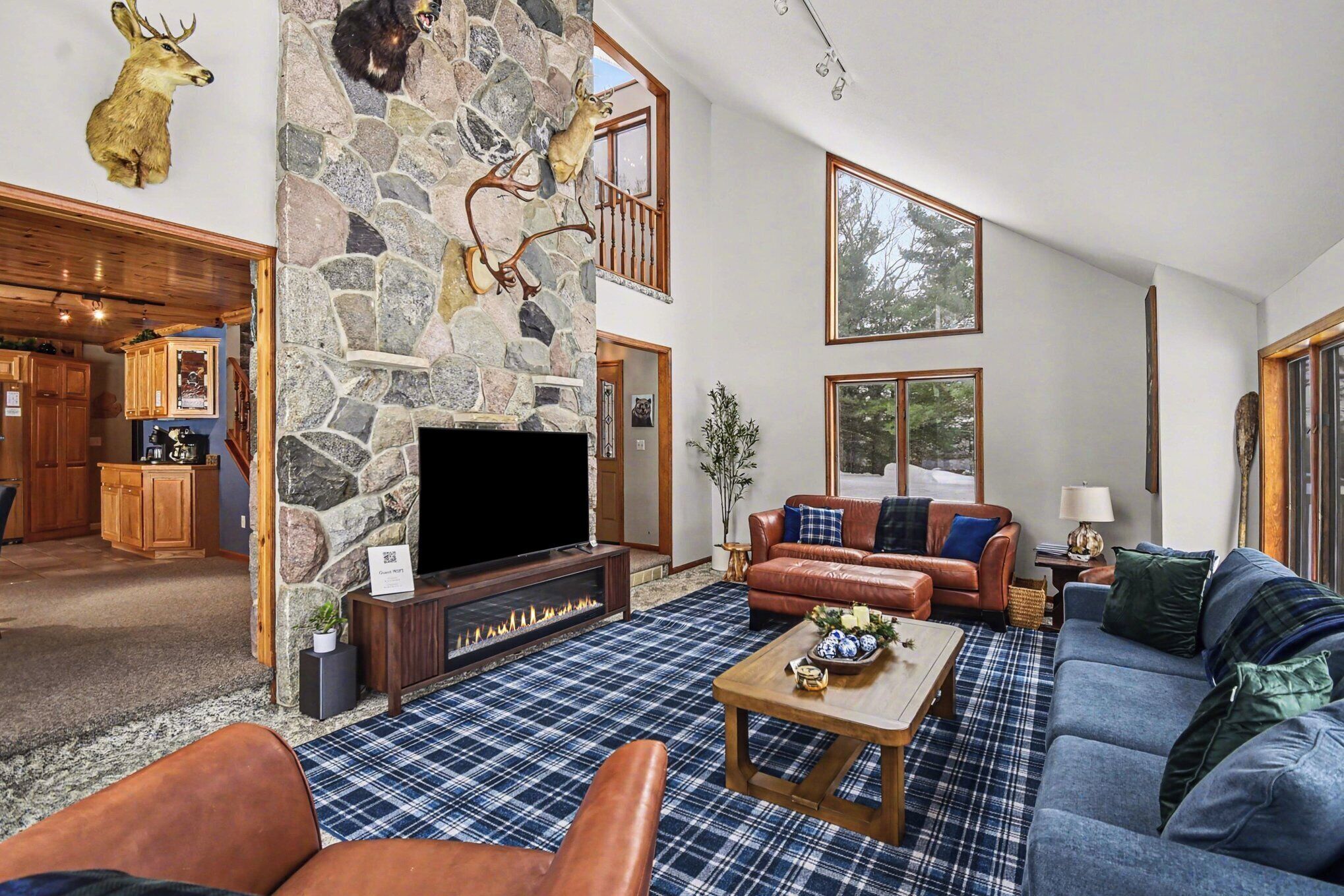 Spacious main-floor living room next to the kitchen with views of McCullum Lake 
