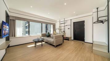 Premier Suite, City View | Living room | TV