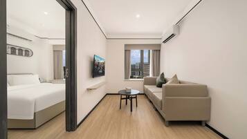 Panoramic Suite, City View | Desk, laptop workspace, blackout curtains, free WiFi