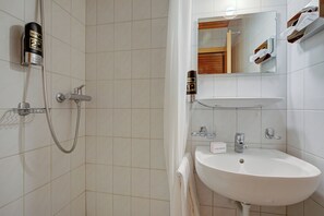 A bathroom with a shower, sink, and mirror. - Hotel Relais Alpin Single Ski In-Out 3, Les Mosses, Switzerland (Les Mosses)