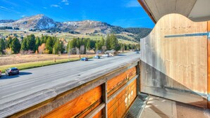 A view from a balcony overlooking a road with cars, a mountain, and a clear sky. - Hotel Relais Alpin Family Room & Balcony5 136, Les Mosses, Switzerland (Les Mosses)