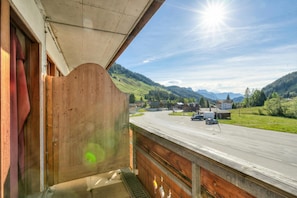 Ein Balkon mit Blick auf eine Straße und Berge.