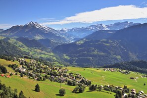 A mountainous landscape with a village nestled in the valley. - Hotel Relais Alpin Twin Room Ski In-Out10 137, Les Mosses, Switzerland (Les Mosses)