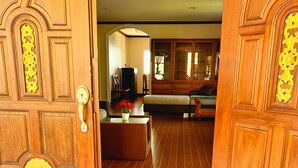 A wooden door with intricate carvings and a brass handle. - Sunset Ocean View 3-king bed Villa Directly Above Patong (Phuket)
