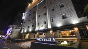 A hotel with a modern facade, illuminated signage, and a prominent entrance. - Swissbella Hotel (Pohang)