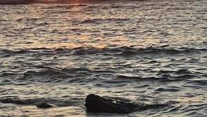 A sunset over the ocean with waves and a rock formation in the foreground. - Shuktara Beach Resort Saint Martin (Saint Martin's Island)