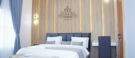 A modern bedroom with a bed, a bench, and a nightstand.