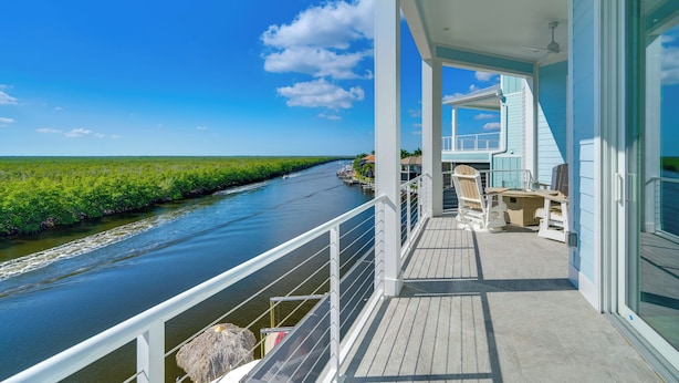 A balcony with a view of a river and a clear sky. - Luxury Group Escape in Cape Coral’s Cape Harbour! (Cape Coral)