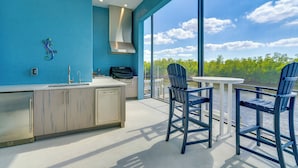 A modern kitchen with a large window overlooking a scenic view. - Luxury Group Escape in Cape Coral’s Cape Harbour! (Cape Coral)