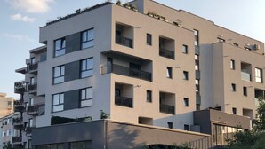 A multi-story residential building with balconies, large windows, and a flat roof with greenery. - "Relax Cluj Apartment" by Interhome (Cluj-Napoca)