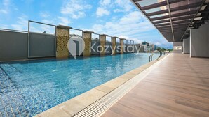 A swimming pool with a clear blue sky in the background. - Hesrin by Kozystay - Sentul (Bogor)