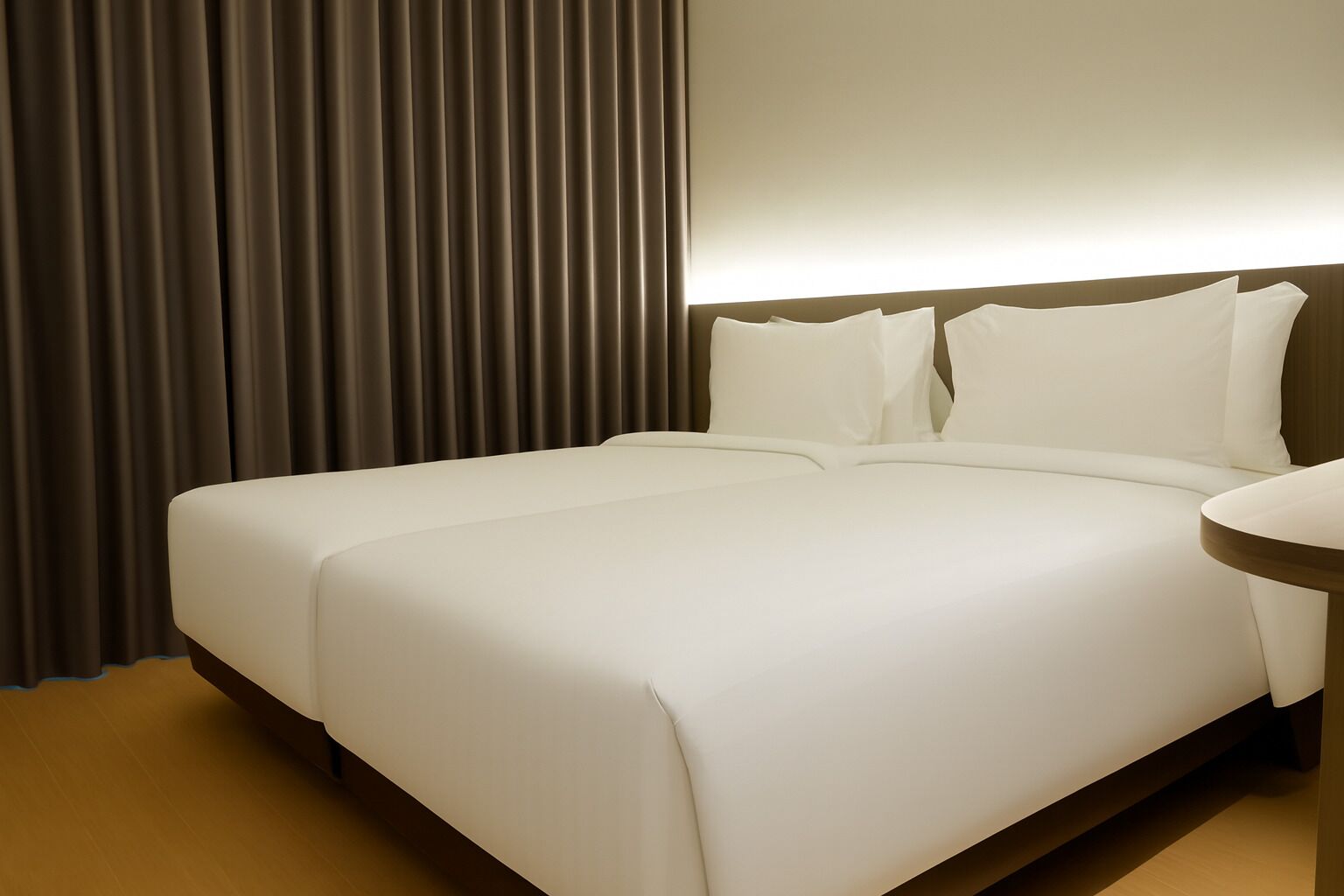 A hotel room with a large bed, a bedside table, and a curtain.