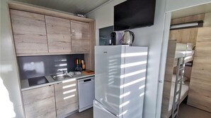 A compact kitchen with wooden cabinets, a white refrigerator, a sink, and a coffee maker. - 2 bedroom lovely home in Privlaka (Privlaka)