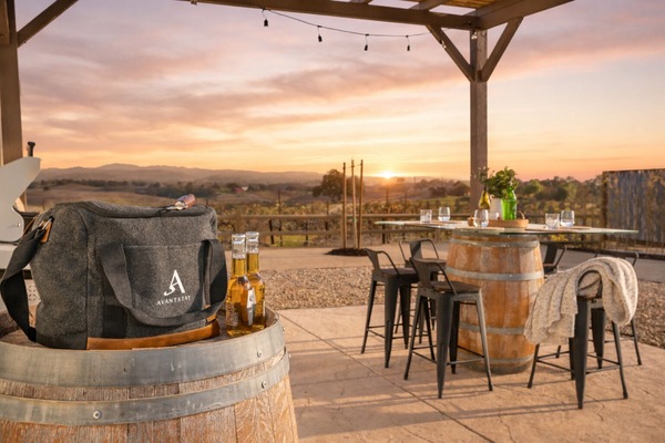 Gather outdoors for wine and hillside scenery at dusk.