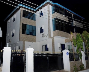 Front of property - evening/night - Vine Apartment (Abuja)