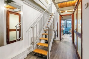 A staircase with wooden steps and metal railings, leading to a room with a view. - Central Apt Near Old Market Square with Parking (Nottingham)