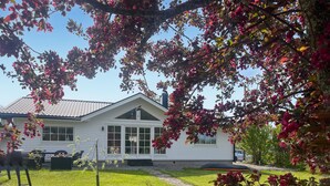 A white house with a gabled roof and a front porch.
