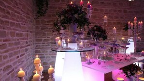 A table set with candles, flowers, and glassware, likely for a special event. - VILLA NASCA - Ville Carborello (Castelraimondo)