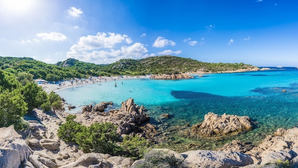 A coastal landscape with clear turquoise waters, rocky terrain, and a beach area. - Lovely Apartment by the Beach (Arzachena)