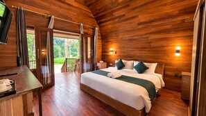 A wooden-paneled room with a bed, bedside tables, and a view of greenery outside. - The Jungle Pots (Payangan)