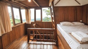 A wooden cabin room with a bed, a bench, and large windows offering a view. - Dulang Resort & Resto (Lembang)