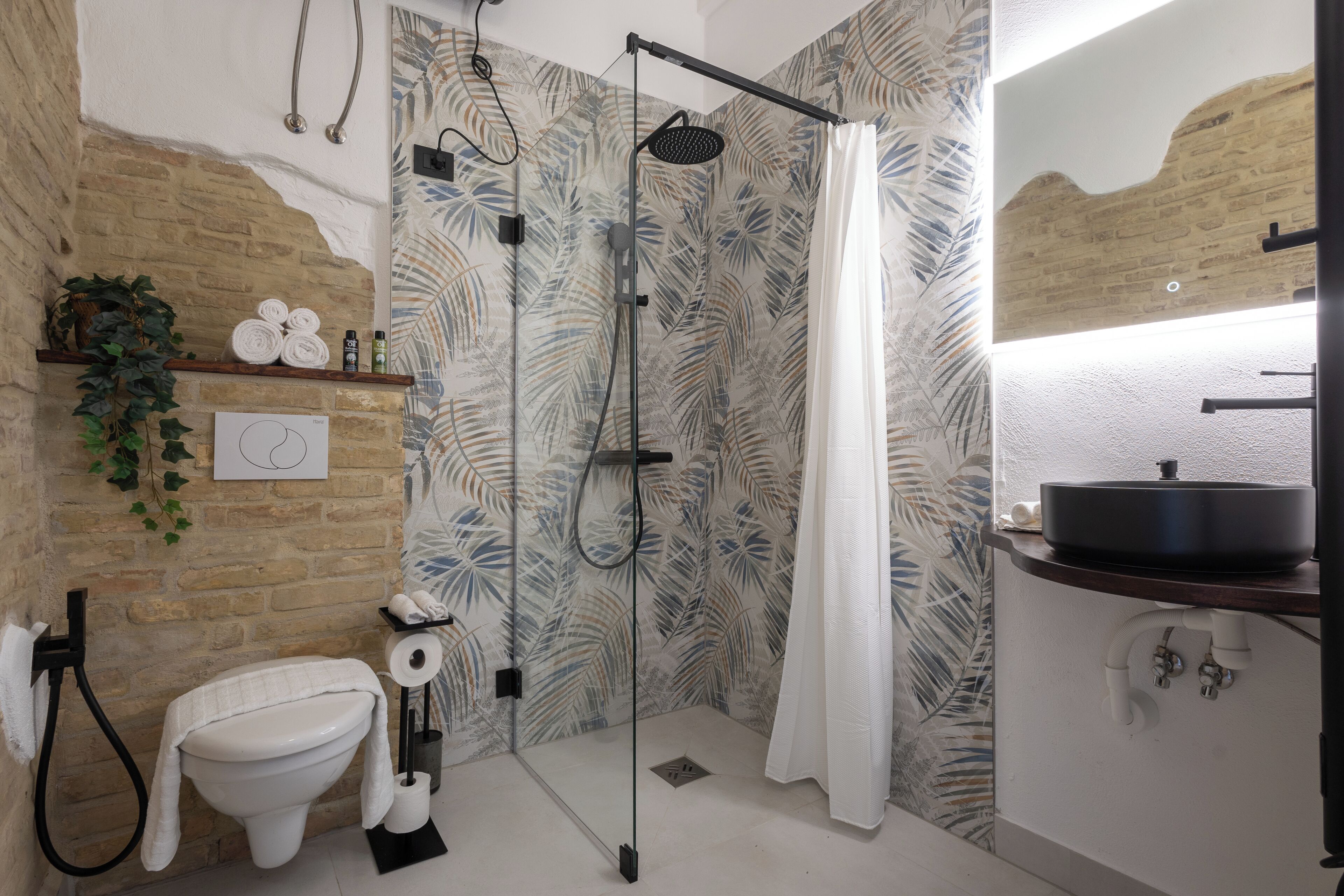 A bathroom with a shower, toilet, and sink.