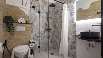 A bathroom with a shower, toilet, and sink.