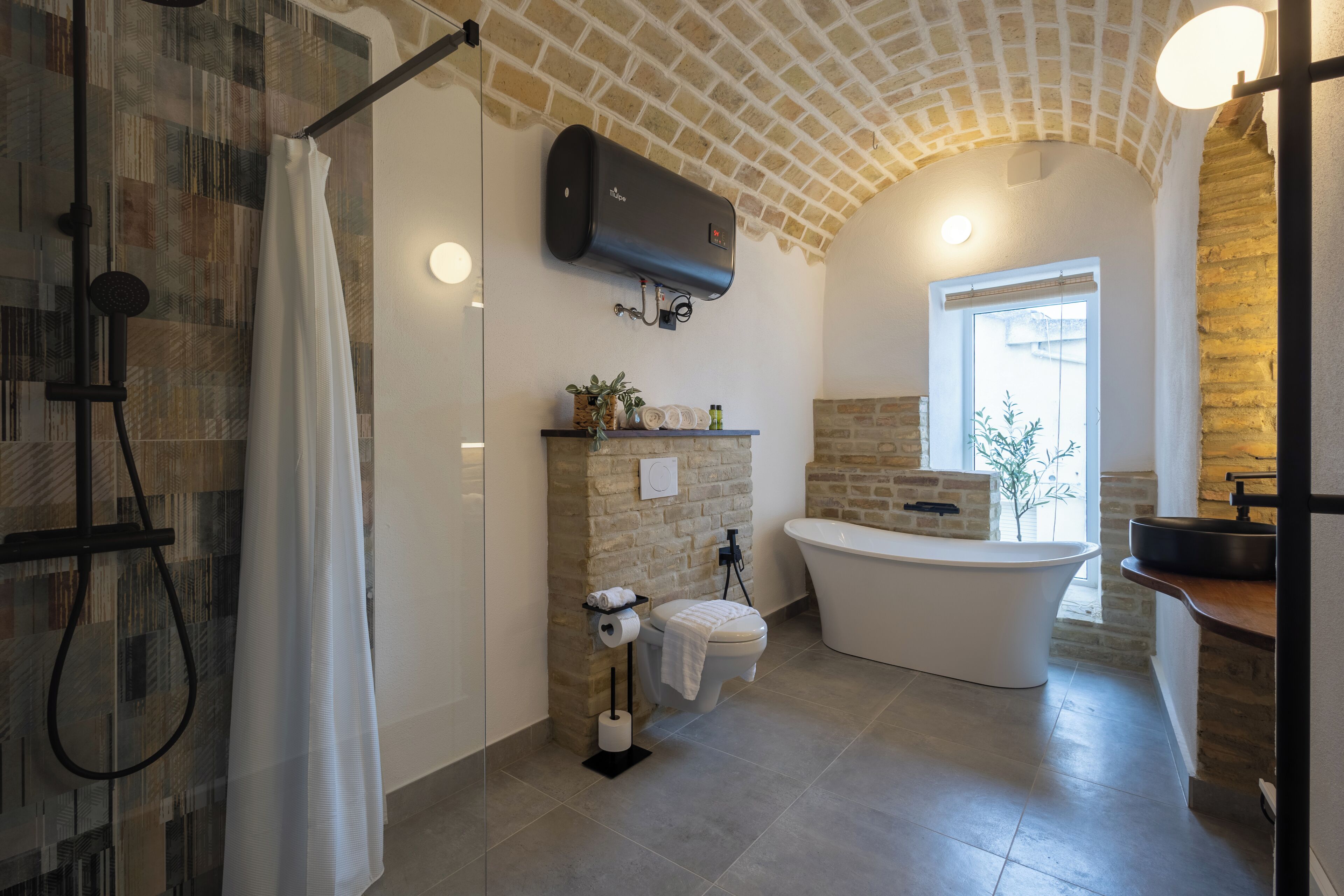 A modern bathroom with a shower, toilet, and bathtub.