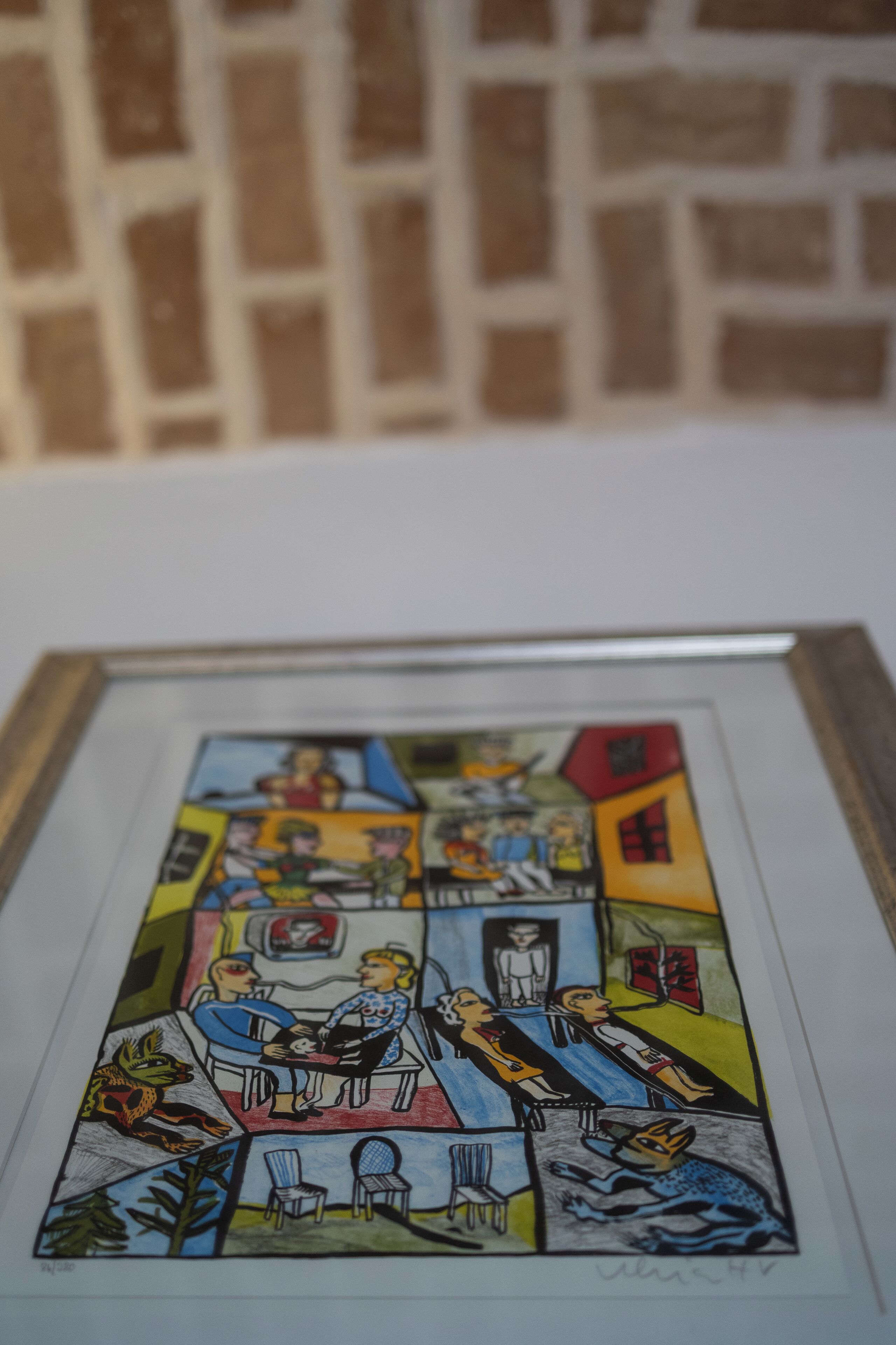 A framed comic-style artwork with various panels depicting scenes of people and animals in different settings.