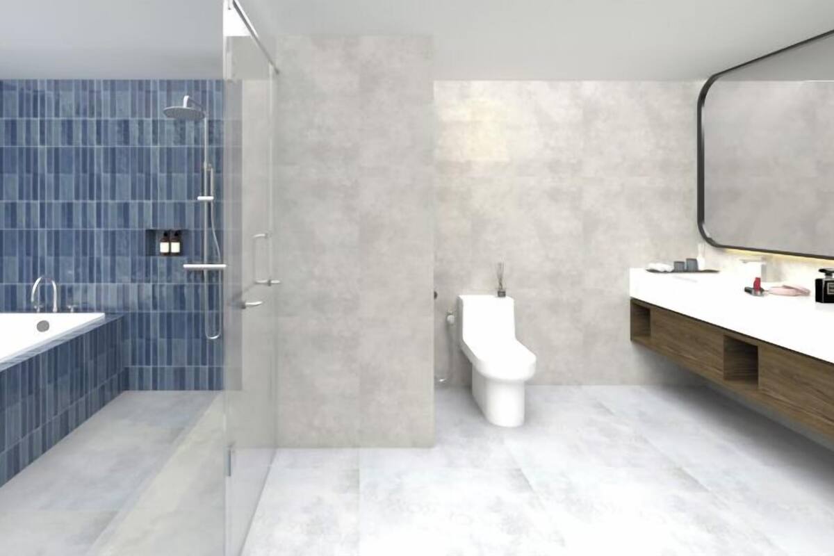 A modern bathroom with a large bathtub, a toilet, and a vanity with a mirror.