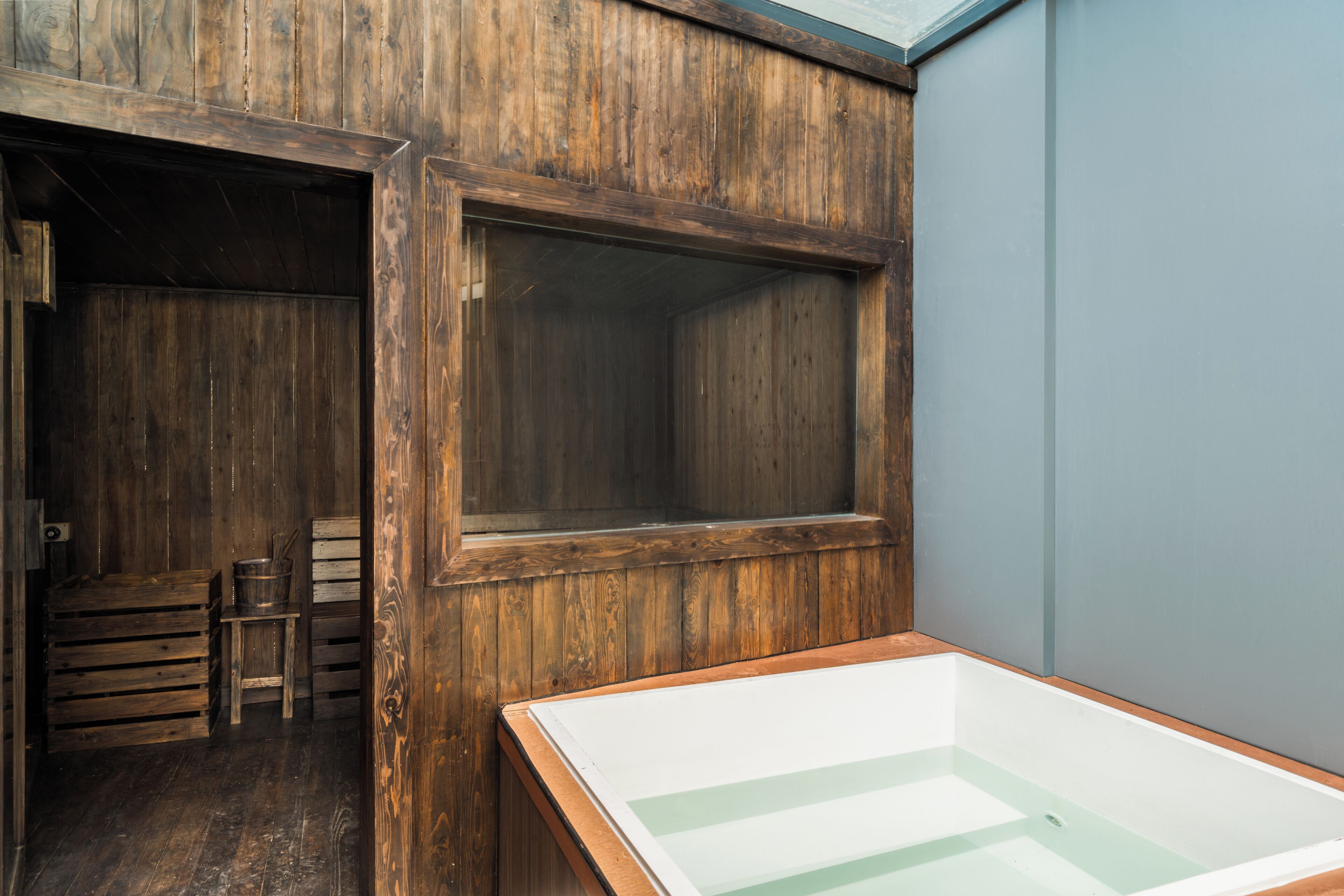 A room with wooden walls and a large window.