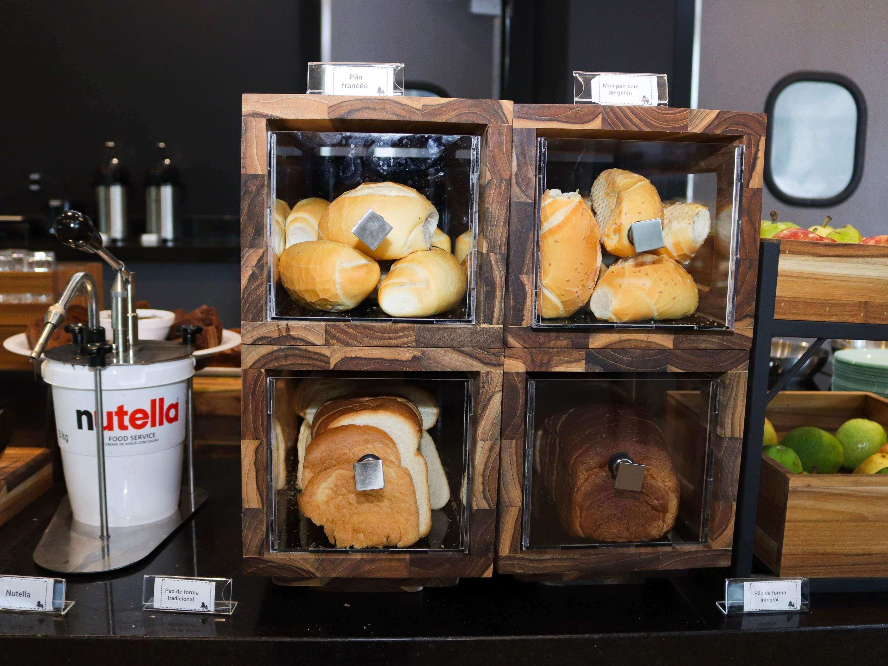 A display of pastries in a wooden box with labels.