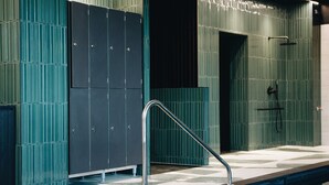 A swimming pool with a metal handrail, tiled walls, and recessed lighting. - Mercure Quimper Kerlic (Quimper)