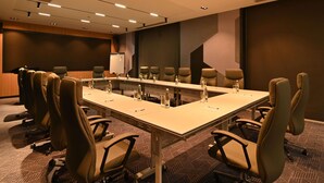 A conference room with a long table, multiple chairs, and a whiteboard. - Mercure Tashkent North (Tashkent)