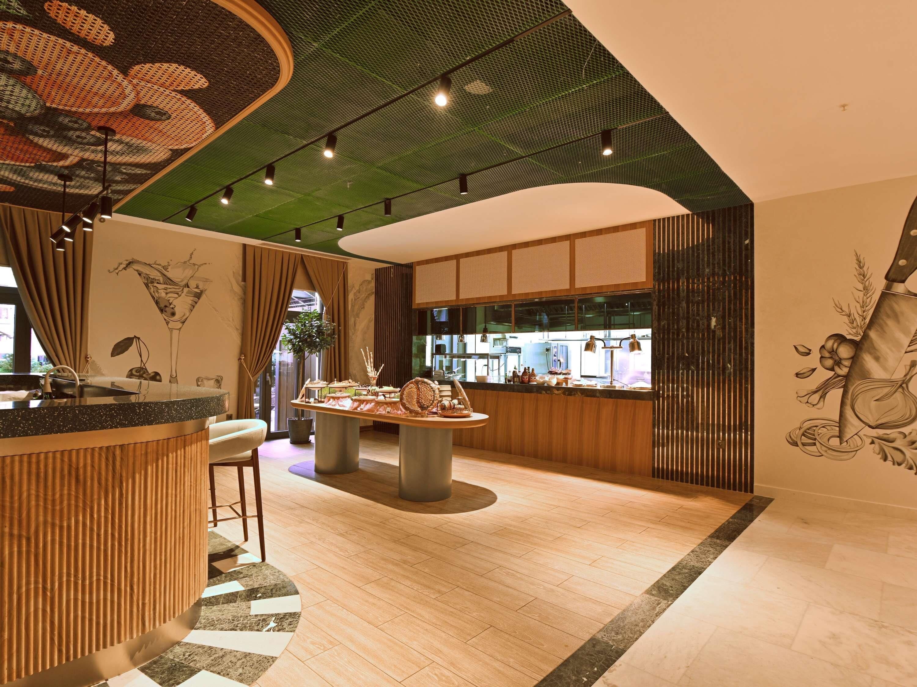 A modern interior with a bar area, a seating arrangement, and a decorative ceiling.