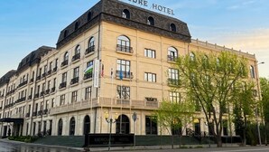 A multi-story building with a sign reading 'Mercure Hotel' at the top.