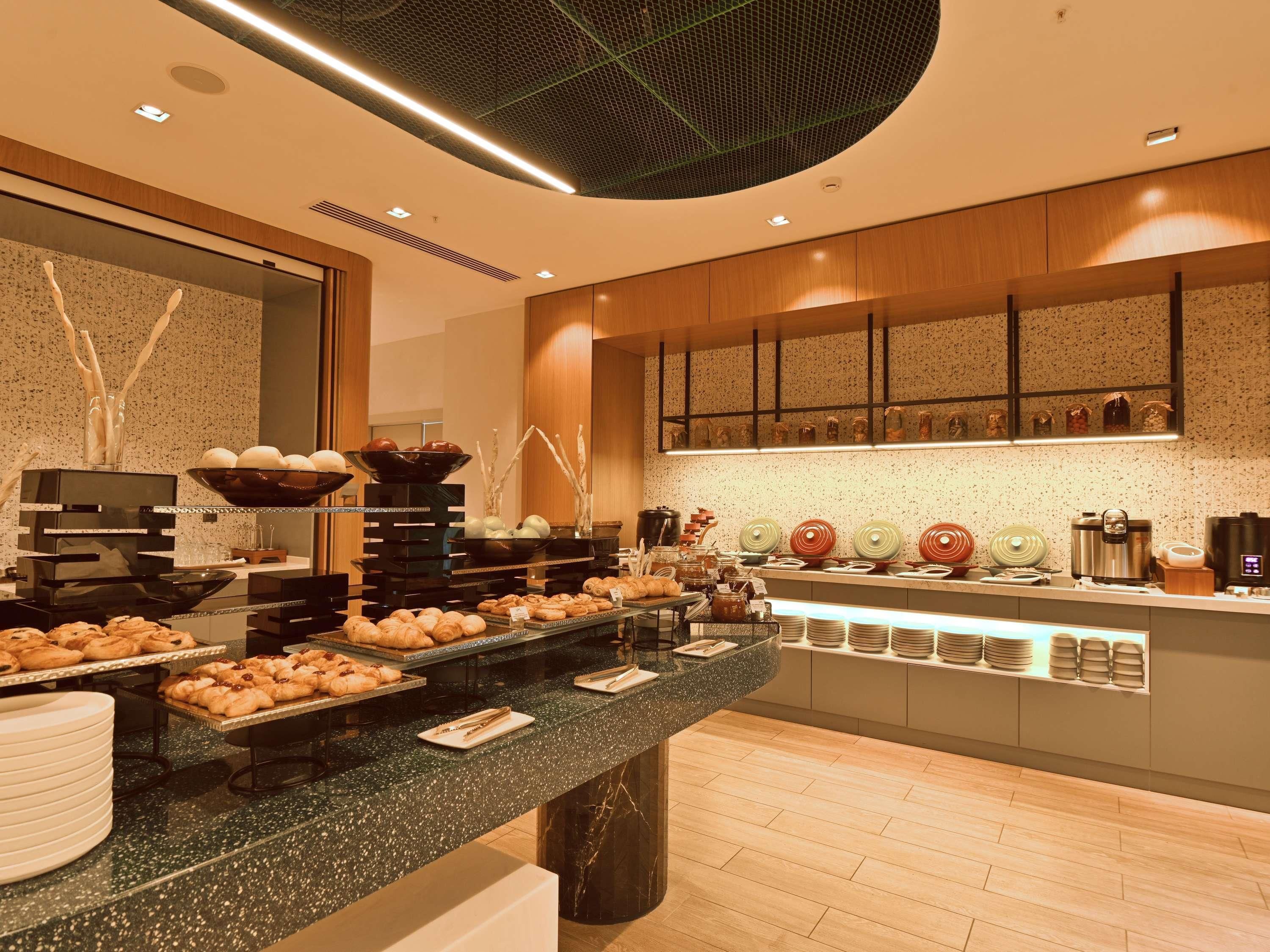 A buffet setup with various food items and kitchen appliances.