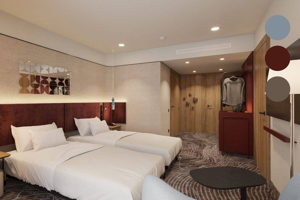 A hotel room with two beds, a desk, a chair, a wardrobe, and a mirror.