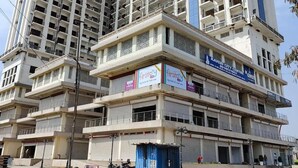 A multi-story building with balconies, a sign for 'Kaveri City Centre', and a 'firstcry' store on the ground floor. - High Sky In (Greater Noida)