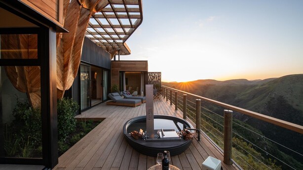 A modern outdoor deck with a hot tub, seating area, and a scenic mountain view. - Mantis Hiddn In Addo (Gqebergha)