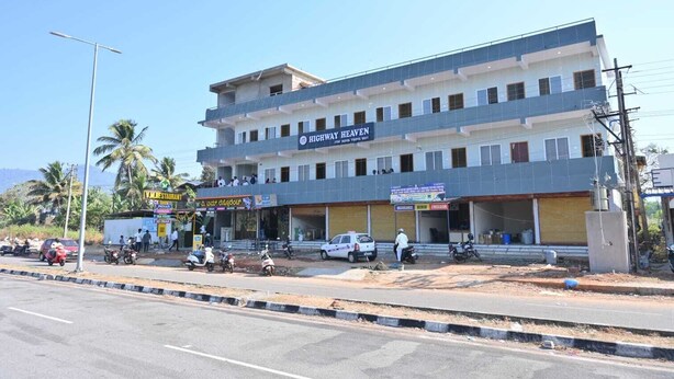 A multi-story building with a sign for "Highway Heaven Hotel & Travel Agency". - Highway Heaven (Bhatkal)