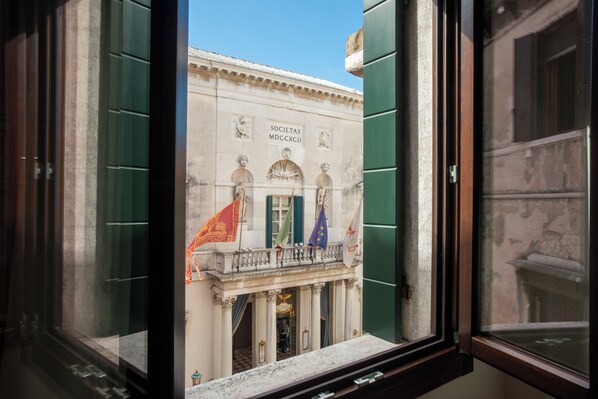 A building facade with classical architecture, including columns and decorative elements. - Fenice Studios (Venice)